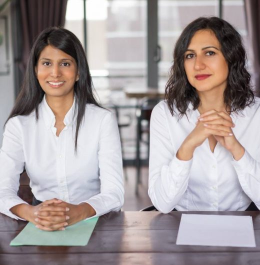 two-positive-female-workers-sitting-desk-modern-office (3)